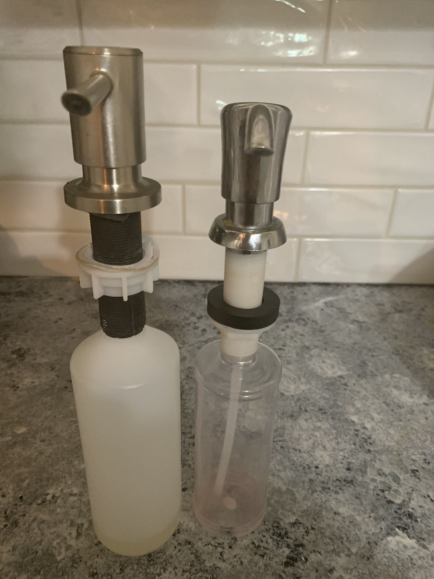 Two kitchen sink soap dispensers