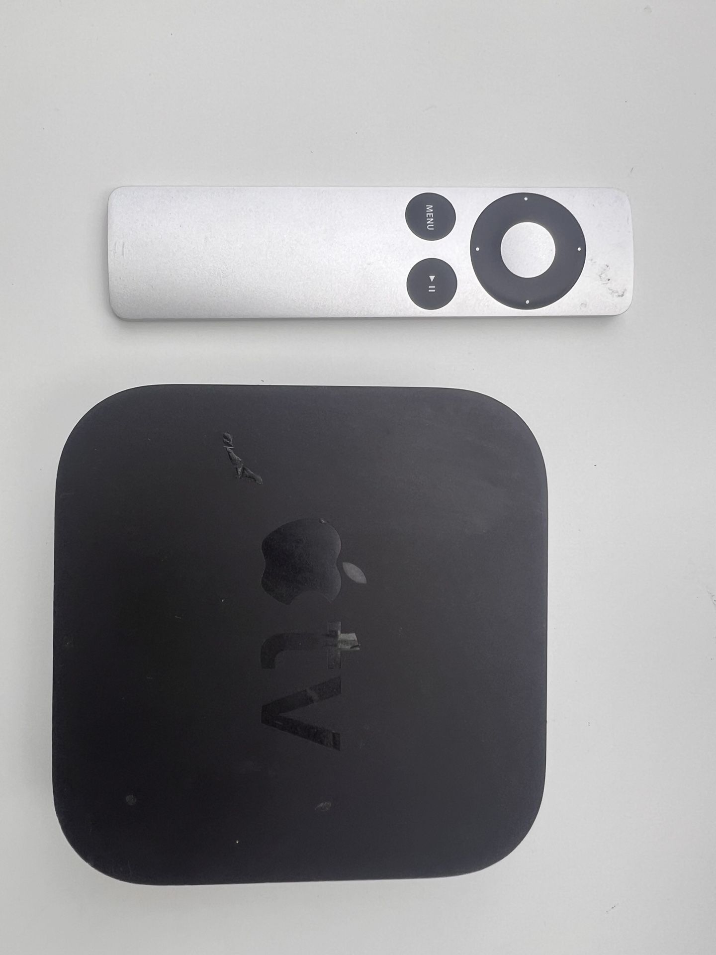 Apple TV which came with an **aluminum Apple Remote
