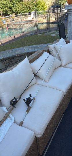 Cork-handled baitcasting fishing rods Mitchell rod and one white REALTREE rod, both equipped with baitcasting Shimano & Daiwa reels.