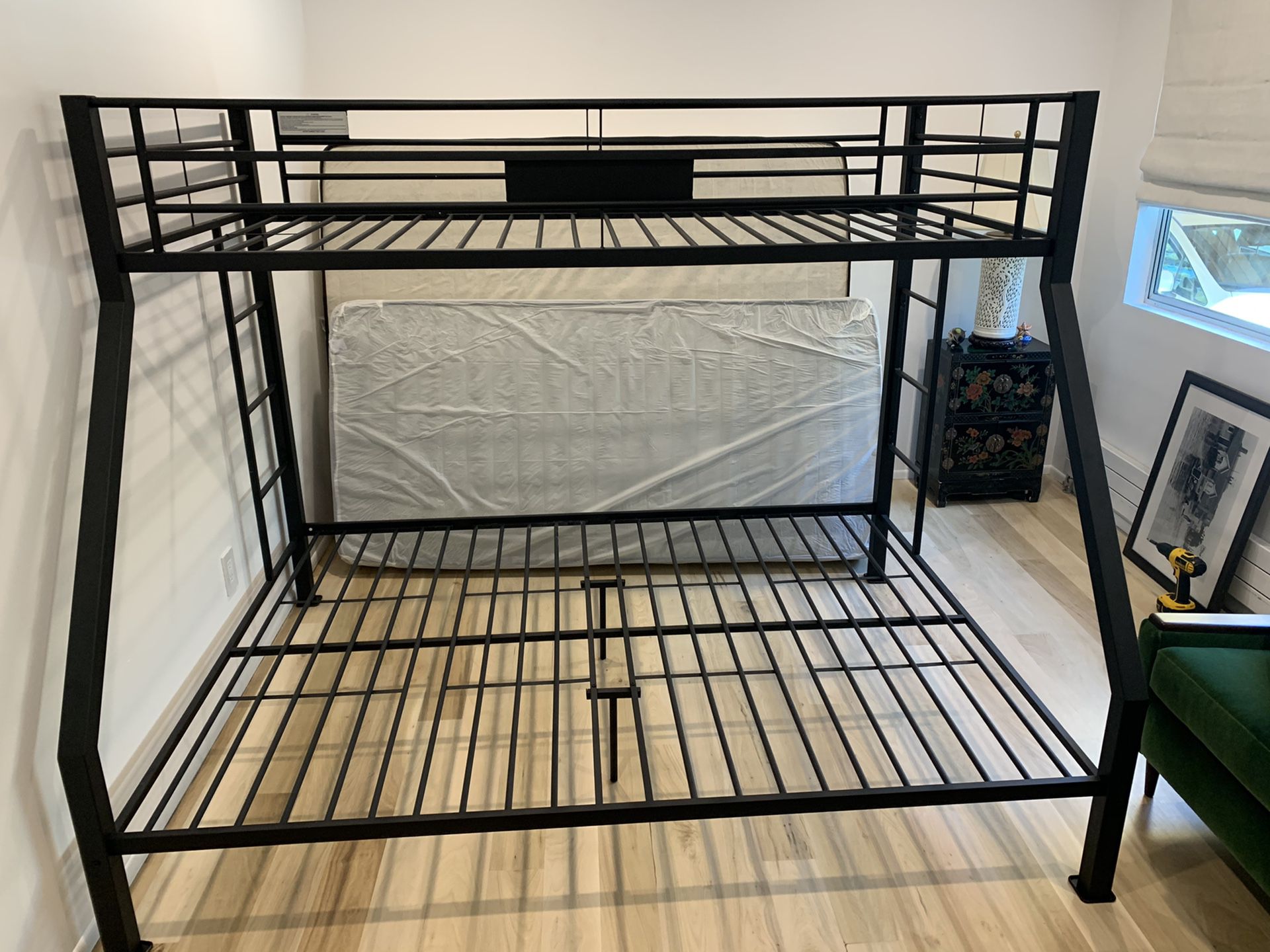 Black metal bunk bed frame with twin on top and /queen on bottom -can be delivered for an extra fee