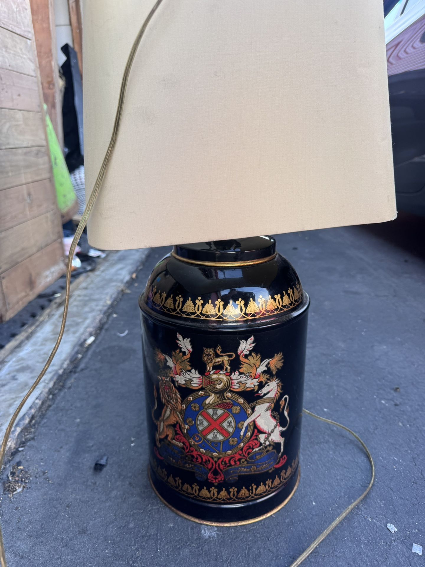 vintage or antique tole tea canister that has been converted into a table lamp.