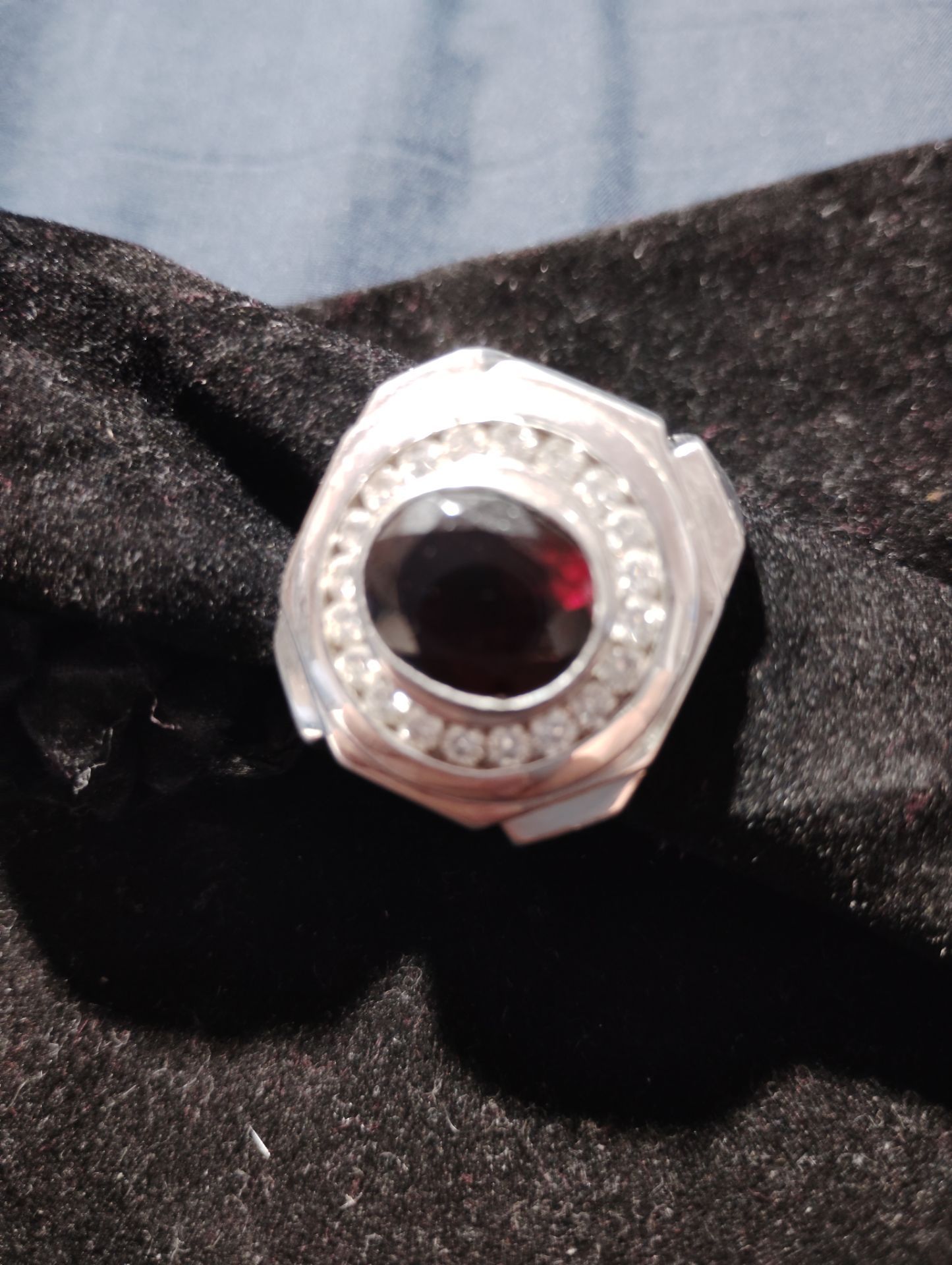 Used 14k ring .. solid white gold 22.8 g with approx...5 carat oval red Garnet center Stone..and 2 carat diamond...