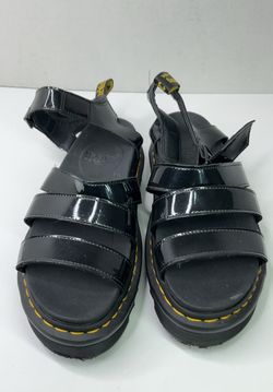 Dr. Martens Blaire sandals featuring a distinct glossy black patent leather.