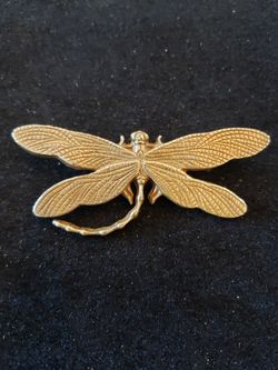 $8. Dragonfly brooch. Gold tone. 2.5 in wide and 1 in long.