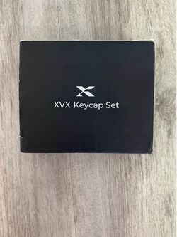 XVX Keycap Set for mechanical keyboards. Black colorway. Open-box condition with light shelf wear to the outer packaging. Keycap set appears unused.  