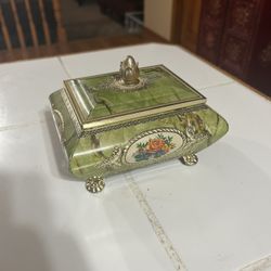vintage Harry Vincent Ltd. "Blue Bird Confectionery" tin, which is a collectible item.  The tin has a green faux marble finish with gold trim, a flora