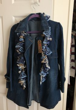 Double breasted denim jacket or 3/4 length. Never worn size L. The buttonholes in the front have never been opened