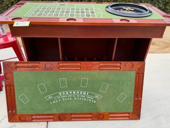 Wooden Bar with casino style games inside and 2 sturdy red Bar stools
