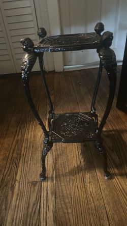 Beautiful heavy , black cast iron plant stand , great condition , measure 21 inches tall and 10 inches square $55.00.
