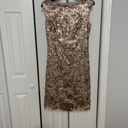 beautiful dress made of gold sequins, worn for a few hours, like new (brand Vince camuto) size 6 also fits size 4