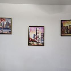 Three framed, abstract cityscape painting