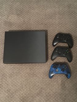 Xbox with three controllers