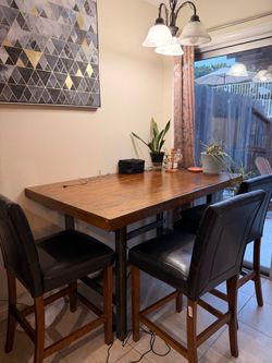 Counter height wood dining table with 4 tufted barstools