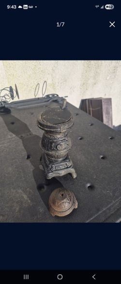 A vintage miniature cast iron pot-belly stove
