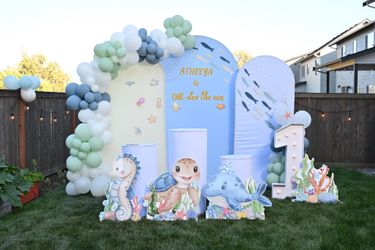 Arch Backdrop, cake pedestal & cover, under the sea animal cutouts, #1 lights.