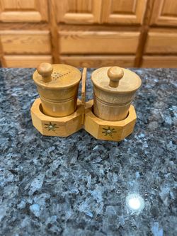 Vintage Wood Hand made pair of Salt and pepper Shakers with holder.  Size 2 3/4 inches tall.  Preowned.  Has been on display in a cabinet with a very 