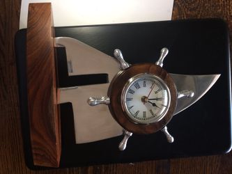 Old clock of ships sail and wheel