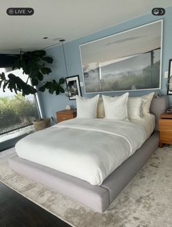This specific bed frame is the Cloud Slipcovered Platform Bed from Restoration Hardware