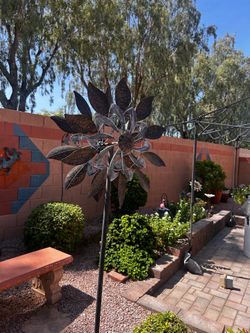 Spinning metal yard art flower