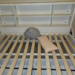 Full size bed with bookshelf and drawers