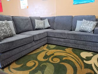 Charcoal gray sectional with nailhead trim