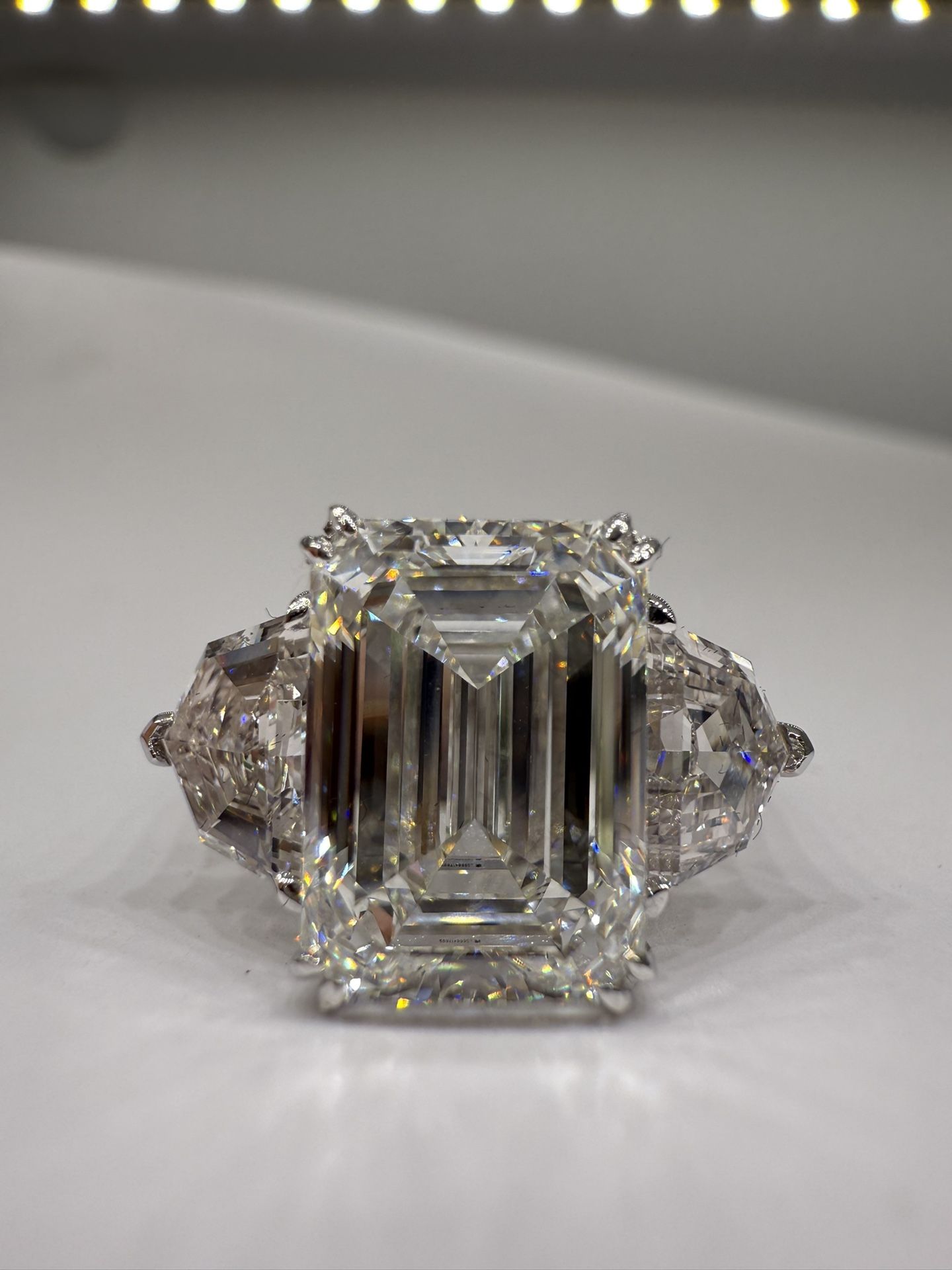 5.10 carat E VVS2 emerald cut lab diamond with Cadillac side stones three stone 
