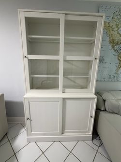 Beautiful IKEA HAVSTA storage cabinet with glass sliding doors, in white.