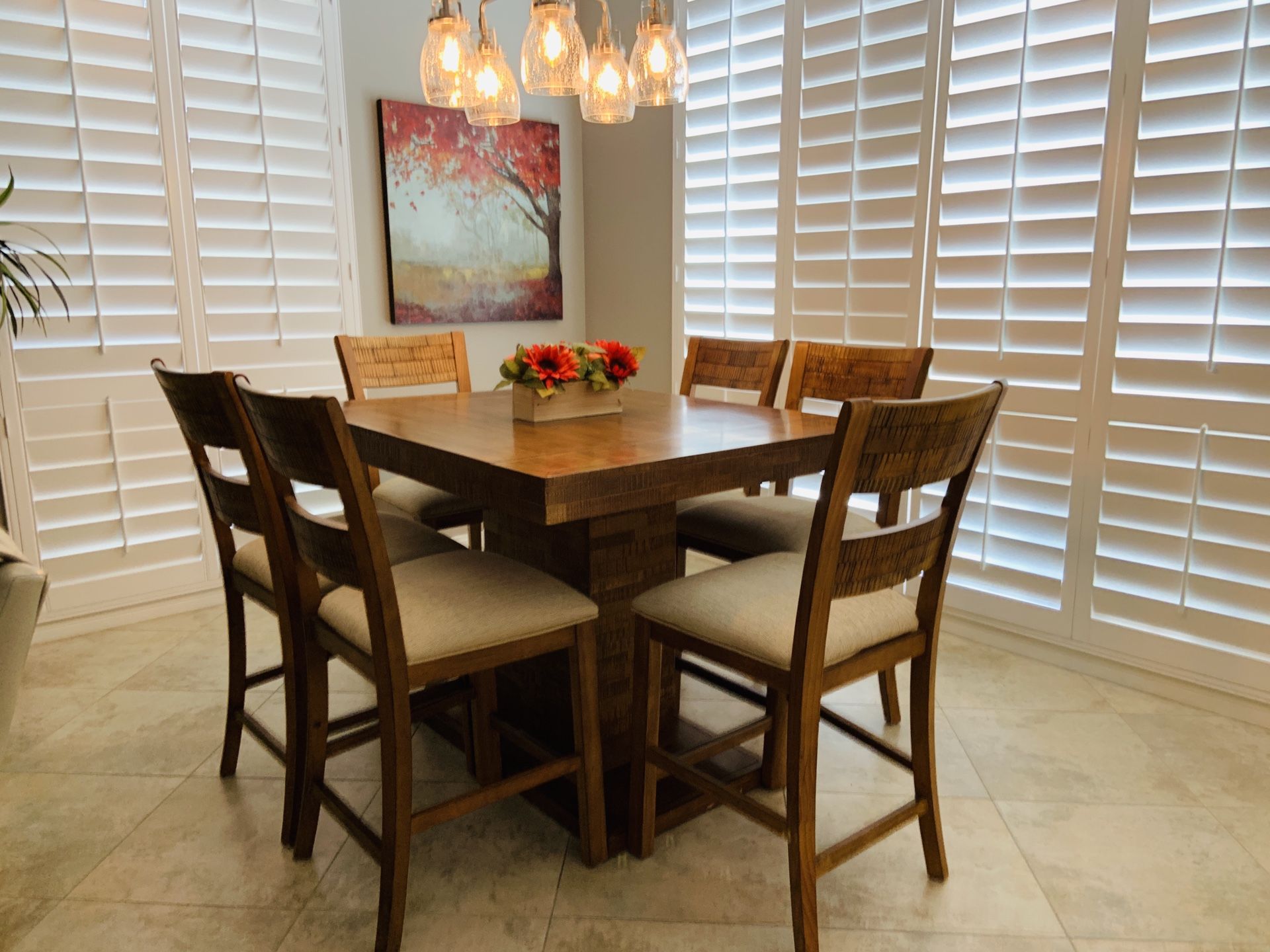 Expandable dining table with eight chairs