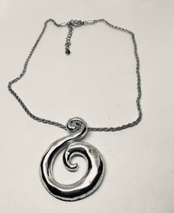Silver tone necklace with large pendant with accent crystal