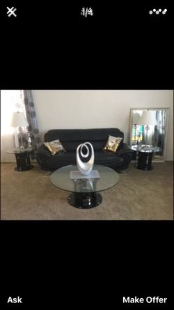 Two leather couches two side tables one coffee table