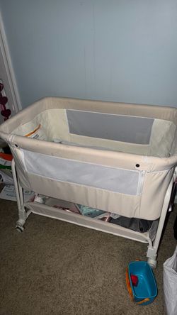 on the bottom Cream color Baby bassinet with storage on the bottom