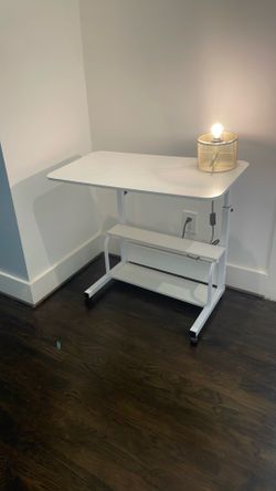 White desk adjustable height and on rollers for east movement