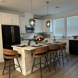 Four Wooden And Black Leather Counter Height Bar Stools