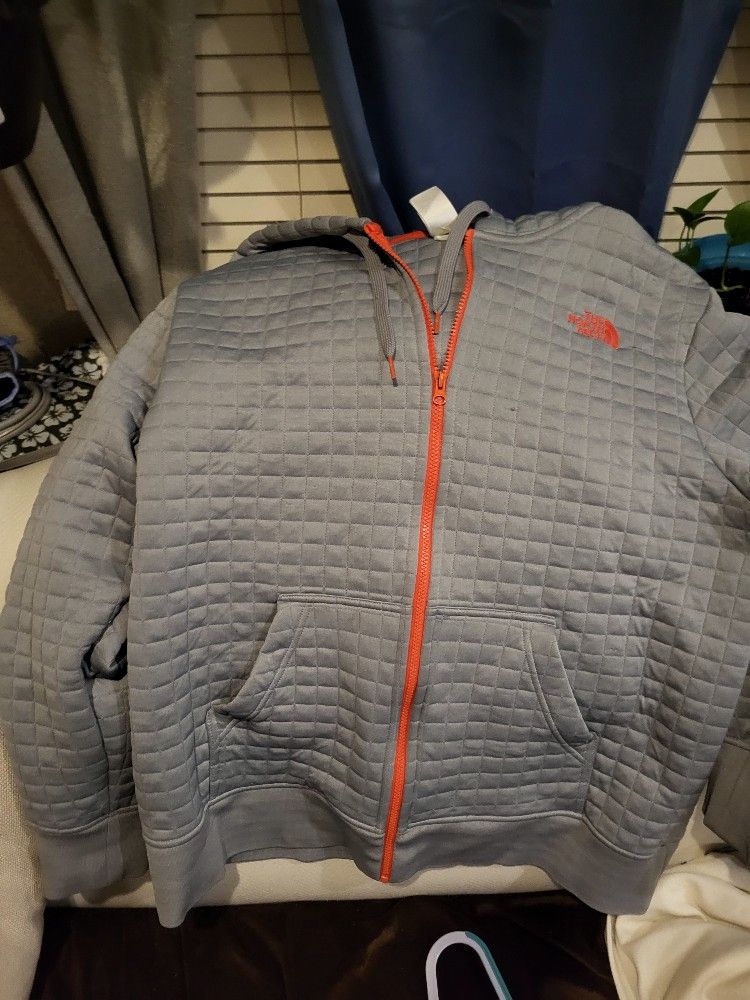 The North Face Longs Peak Quilted Full Zip Hoodie in grey with an orange zipper.