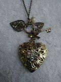 Vintage gold tone locket and charms