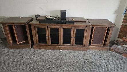 Large tv stand comes with speakers.