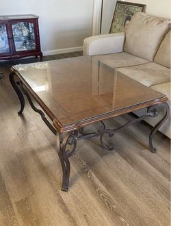 Traditional Wood & glass coffee table with scrolled iron legs and a removable glass top.