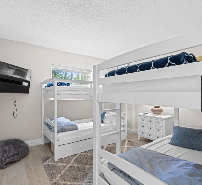 Two white twin bed bunkbeds