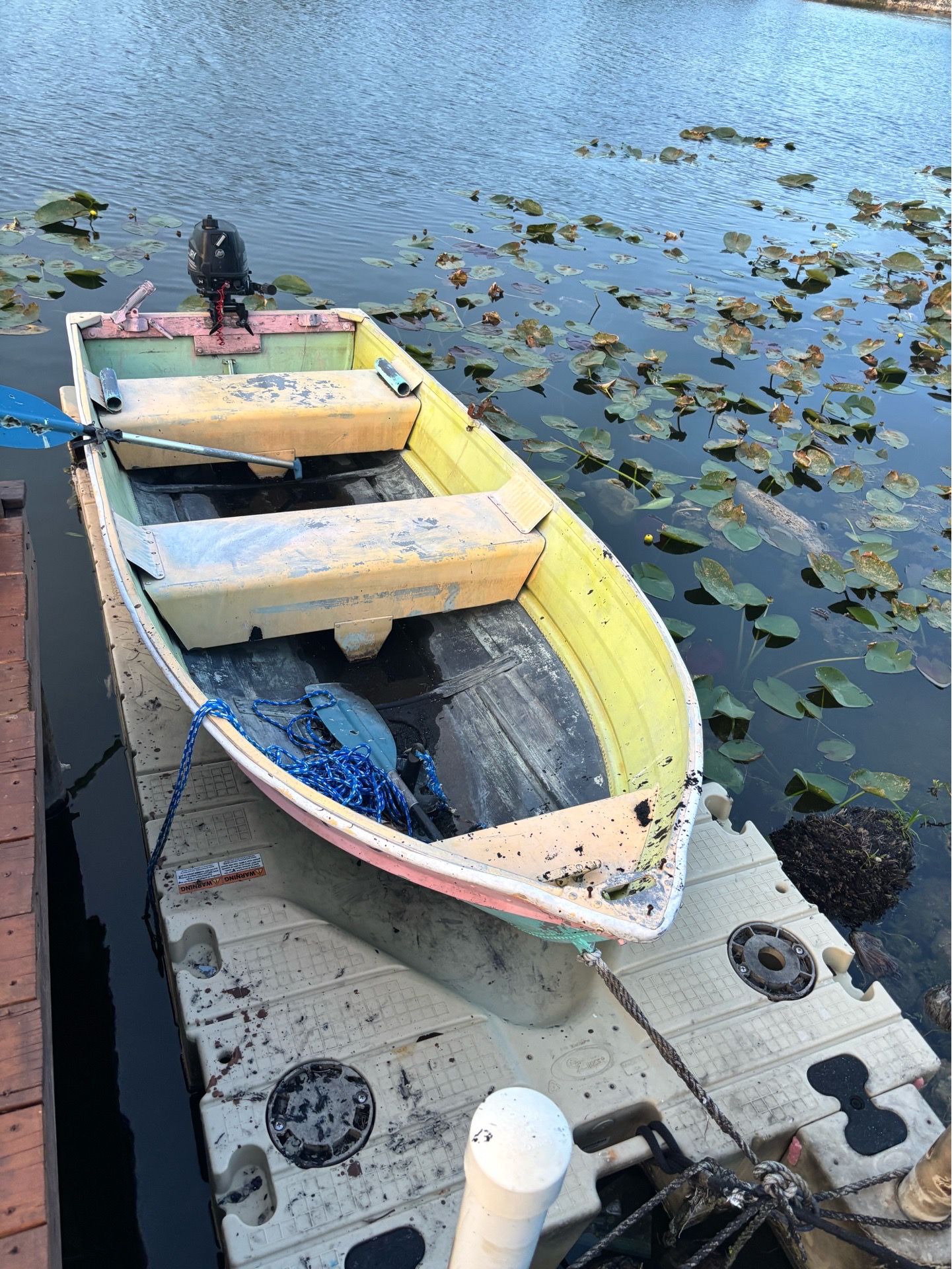 Motorized fishing boat with floating platform included.