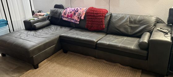 Ashley Furniture-Black faux leather Nokomis sectional sofa 