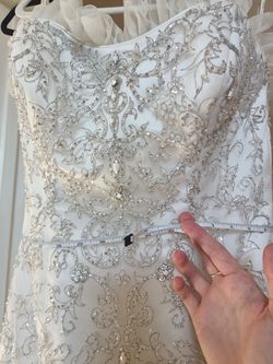 Oleg Cassini White bead embroidered wedding dress Size 10 Ivory mermaid style with a sweetheart neckline

Condition is used with a couple small tears 