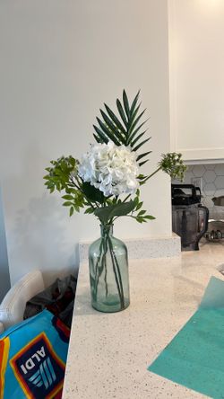 Artificial plant with glass container as pot