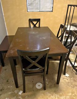 Table with 4 chairs and a bench
