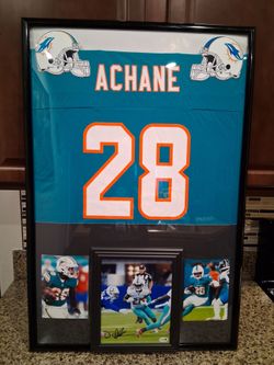 DEVON ACHANE WITH THE MIAMI DOLPHINS, BRANDED AND AUTHENTIC FRAMED JERSEY, WITH SIGNED PHOTO /COA.