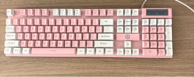 Pink and white wired keyboard