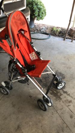 Orange  stroller in  great condition heavy duty