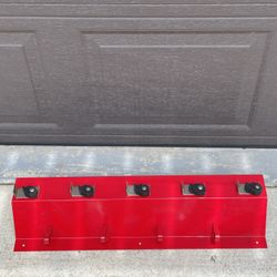 Red metal wall broom rack with shelf