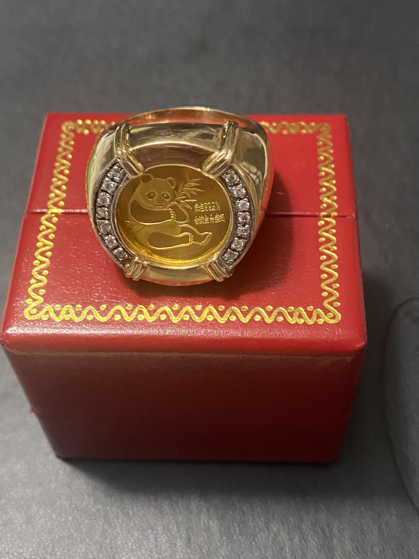 Collectible ring with 24 carat panda coin. The band is 10 carat, size 12. I paid 4500, asking for $2,000 firm price.