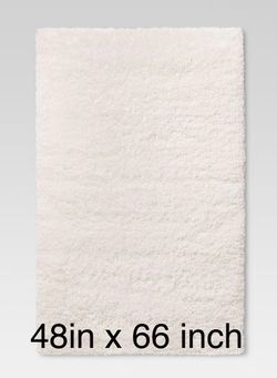Cream shaggy area rug