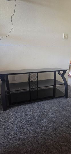 Black glass TV stand with metal rack